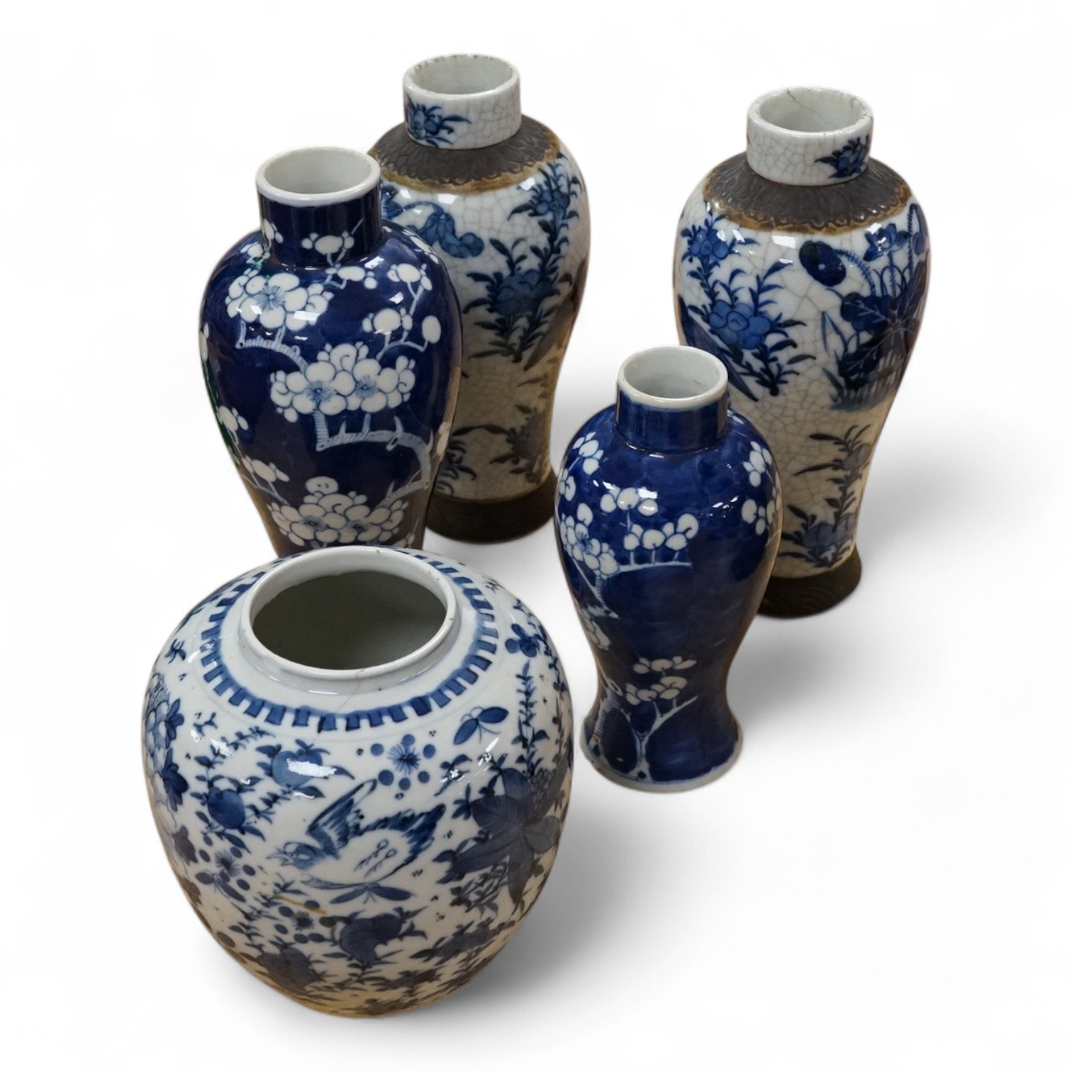 Chinese blue and white porcelain, late 19th century, comprising two prunus vases, two crackle glaze vases and a 'Bird and Flowers' jar, tallest crackle glaze vases 23cm